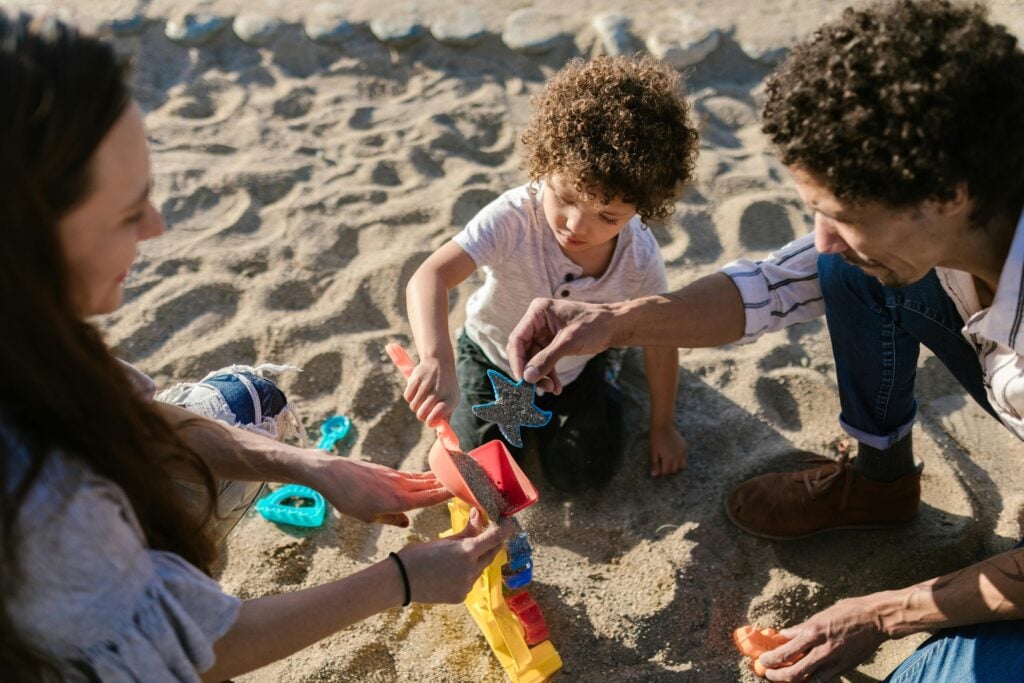 family playing in the sand